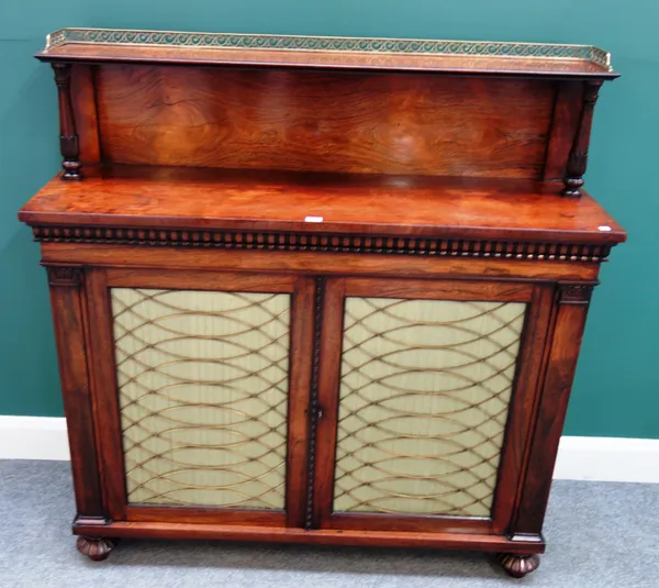 A Regency rosewood chiffonier, the brass galleried ledge back over pair of brass grille doors, on melon carved feet, 122cm wide x 128cm high x 38cm de