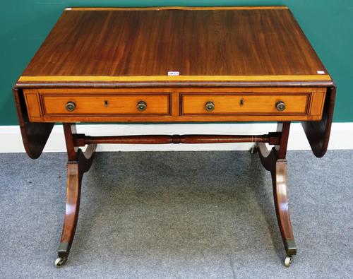 A Regency satinwood banded mahogany sofa table, with pair of frieze drawers and dummy opposing, on four downswept supports, 92cm across, 148cm across