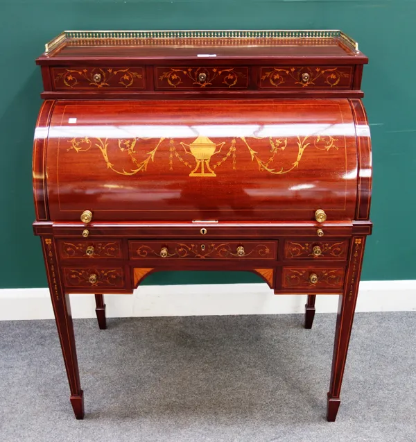 A late 19th century marquetry inlaid mahogany cylinder bureau, the galleried brass top over three short drawers and pull out fitted interior, over fiv
