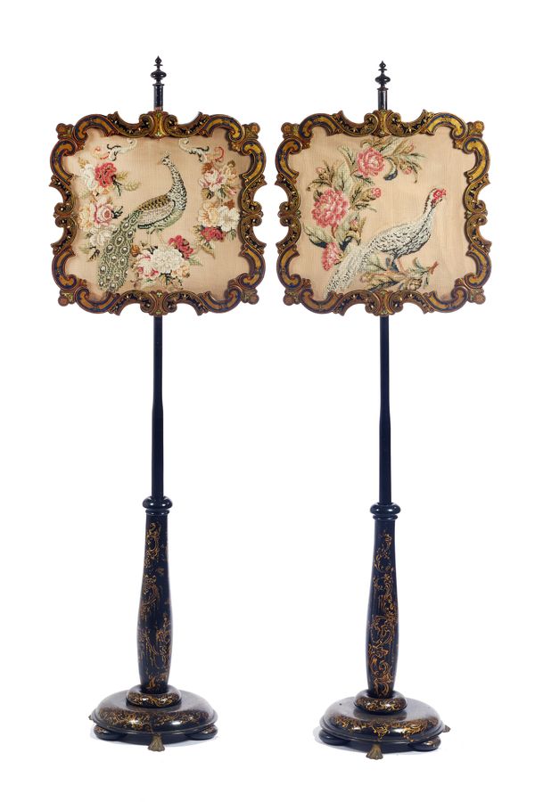A pair of Victorian polychrome and gilt painted papier mâché pole screens, on flared circular bases and gilt metal lions paw feet, 44cm wide x 150cm