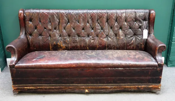 A brass studded tan leather upholstered club sofa, with roll over arms and block feet 190cm wide x 93cm high x 69cm deep.