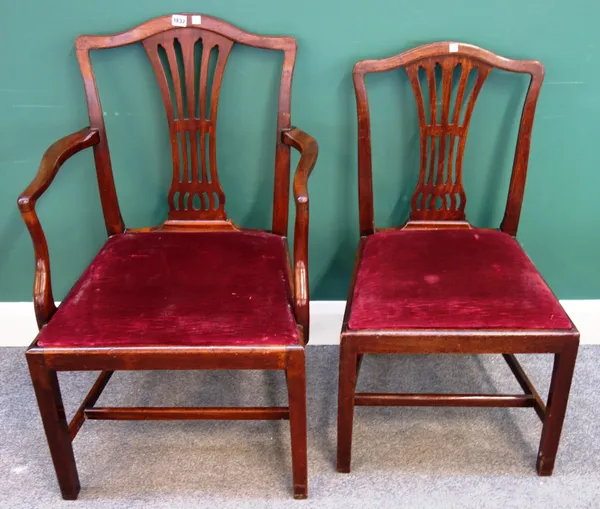 A set of twelve late George III mahogany dining chairs, with pierced splat on tapering square supports, to include a pair of carvers, (12).