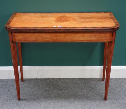 A George III rosewood banded satinwood card table, the fold out rectangular top on square supports, 92cm wide x 73cm high x 43cm deep.