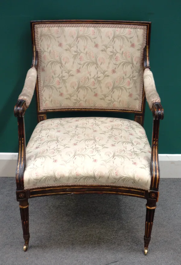 An early 19th century French ebonised parcel gilt open armchair, with concave seat on tapering fluted supports, 59cm wide x 88cm high x 55cm deep.