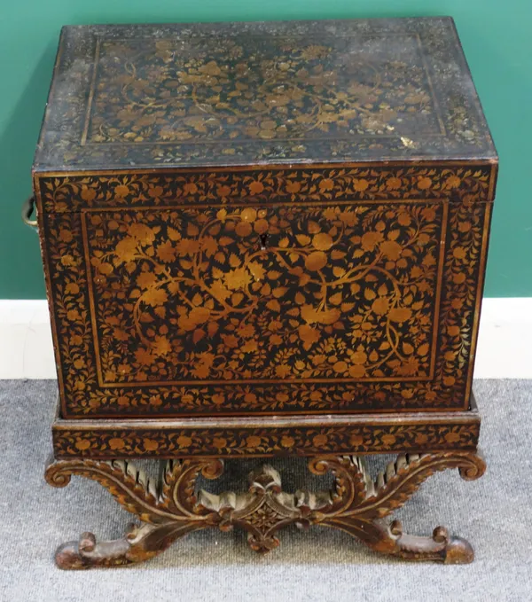 A Regency black lacquer Chinoiserie decorated rectangular lift top box, on a carved and shaped X-frame stand, 59cm wide x 65cm high x 41cm deep.