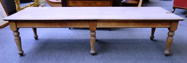 A large 19th century stripped oak farmhouse table, on six turned supports, 105cm wide x 305cm long x 77cm high.