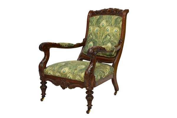 A Victorian carved mahogany open armchair, the crest rail centred by a shield flanked by griffins, above acanthus carved open arms, on turned supports