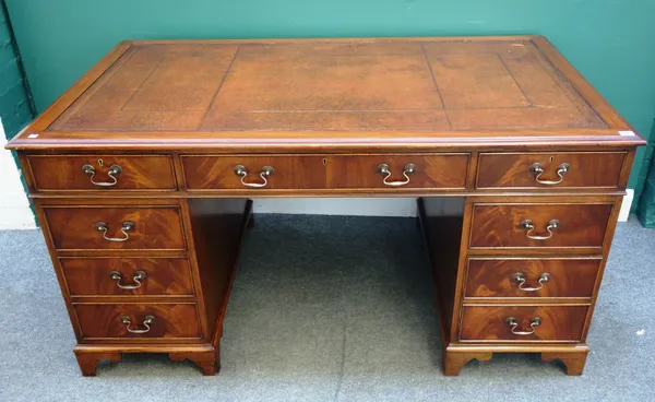 An 18th century style mahogany pedestal desk, with nine drawers about the knee, on bracket feet, 153cm wide x 78cm high x 92cm deep.