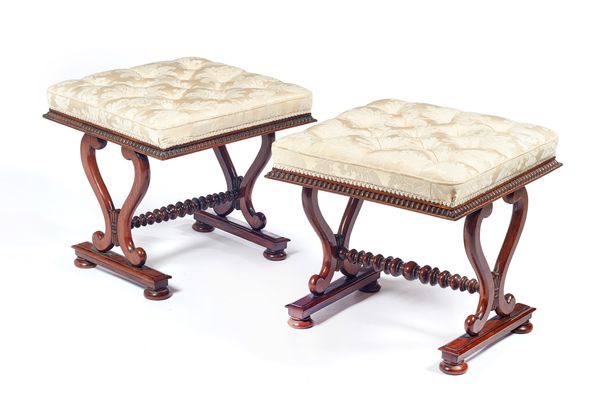 Attributed to William Trotter; a near pair of Regency rosewood framed footstools, each with over stuffed rectangular top on lyre supports united by bo