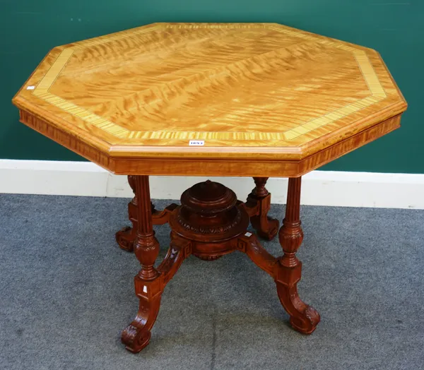 A late 19th century satinwood octagonal occasional table, on four fluted supports united by urn carved stretcher, 99cm wide x 74cm high.