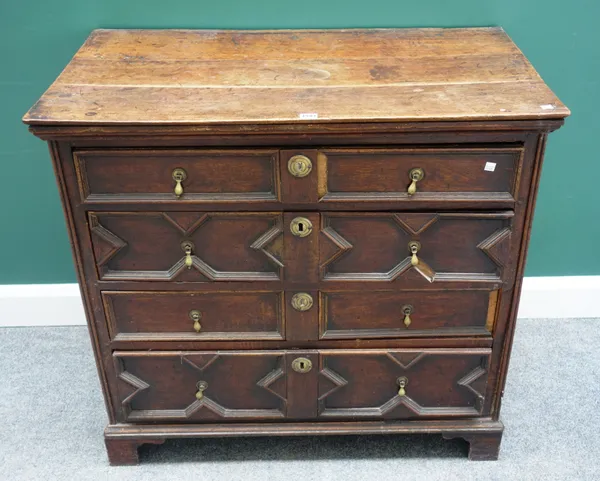 A late 17th century geometric moulded oak chest of four long graduated drawers, on bracket feet, 97cm wide x 91cm high.