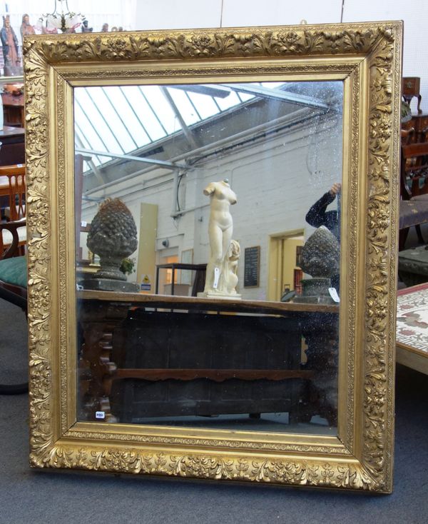 A late 19th century gilt framed rectangular wall mirror, with leaf and floral moulded frame, 140cm wide x 171cm high.