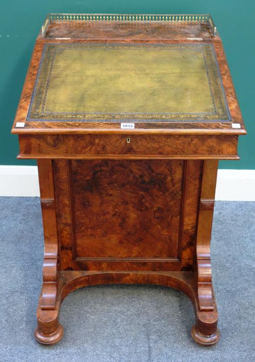 A Victorian figured walnut Davenport, the slope top enclosing a fitted interior, with five side drawers enclosed by locking bar, 59cm wide x 85cm high