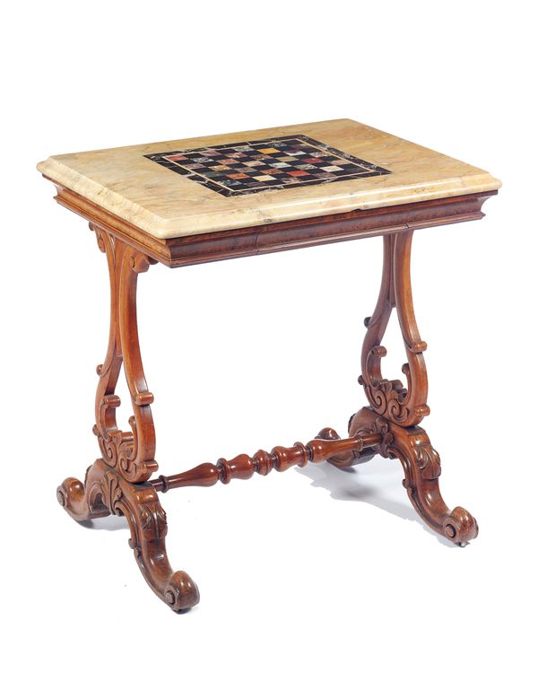 A William IV walnut games table, the rectangular specimen marble chessboard top on a pair of carved and pierced trestle end standards, united by turne