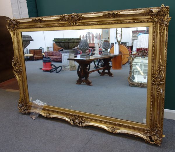 A large gilt framed rectangular wall mirror, late 19th century with applied shell and shield mounted decoration, 160cm wide x 236cm high.