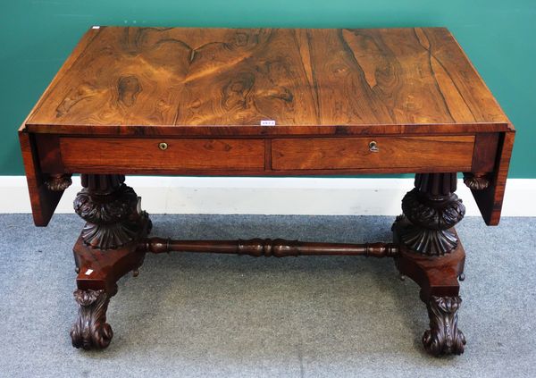 A late George III rosewood sofa table, the drop flap top over pair of frieze drawers, on carved and reeded columns and acanthus scroll feet, 112cm wid