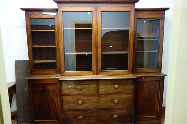 A made-up 19th century mahogany breakfront bookcase, with four glazed upper doors over two short and two long drawers, flanked by cupboards, 242cm wid