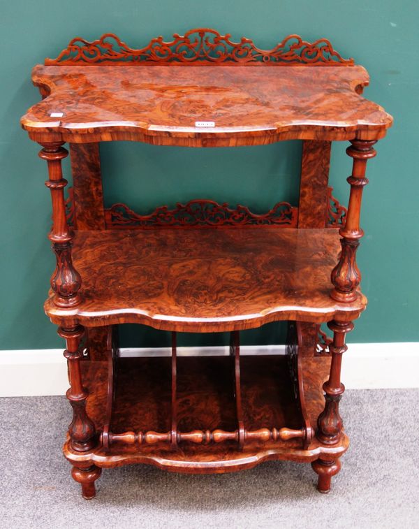 A Victorian figured walnut Canterbury whatnot, with fret carved decoration and two open tiers over a three division base, 65cm wide x 100cm high x 40c