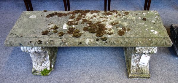 A pair of reconstituted stone benches, each with rectangular slab top with shaped scroll bases, 122cm wide x 43cm deep x 44cm high, 92).