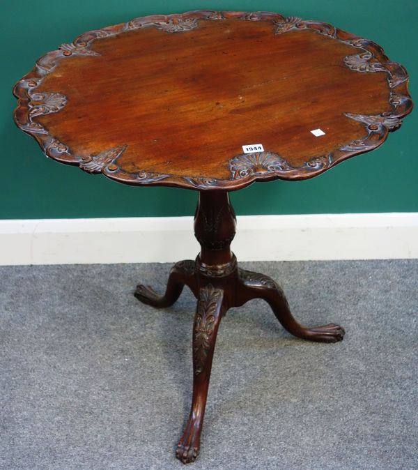 A George III style mahogany occasional table, the carved and shaped top on birdcage support, tripod base and ball and claw feet, 71cm wide x 73cm high