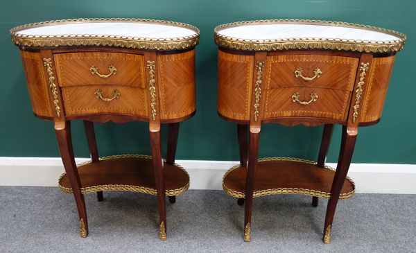 A pair of early 20th century French kidney shaped side tables, each with marble top over gilt metal mounted inlaid mahogany two drawer base united by