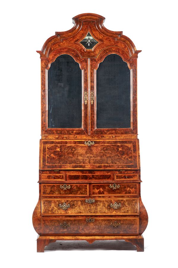 An 18th century Dutch feather banded figured walnut bureau cabinet, the shaped bonnet top over pair of arch mirror panel doors and candle slides, the