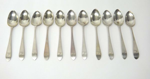 Ten Irish silver dessert spoons, Dublin 1792 and one further Irish silver dessert spoon, Dublin 1806, all crest engraved, combined weight 351 gms.