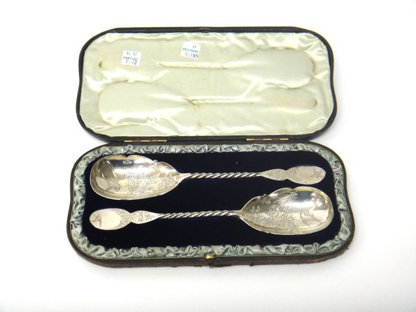 A pair of Victorian silver (formerly gilt) dessert serving spoons, decorated with birds and floral sprays in The Aesthetic Movement taste, each having