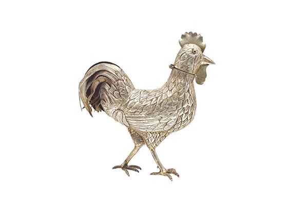 A European model of a standing cockerel, the head opening to reveal a grille pierced with hearts (the hinge broken), height 20cm. Illustrated