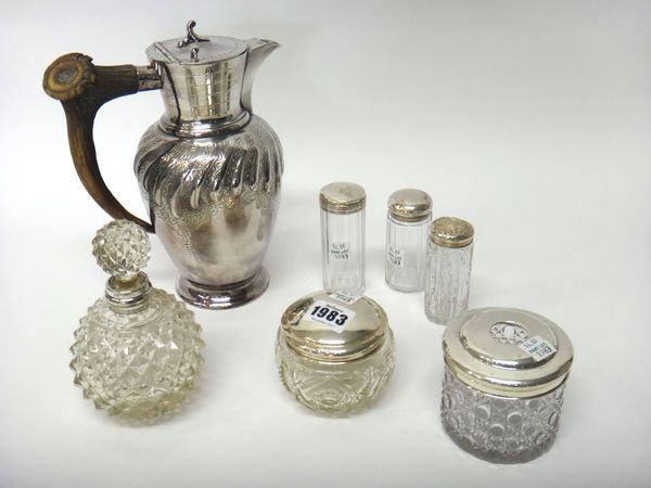 A silver lidded faceted glass toilet jar, London 1920, a silver lidded faceted glass hair tidy jar, Birmingham 1924, a silver topped faceted glass sce