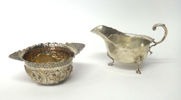 Silver, comprising; a sauceboat, with a shaped rim, scrolling handle and raised on three pad feet, Birmingham 1925 and a Victorian twin handled bowl,