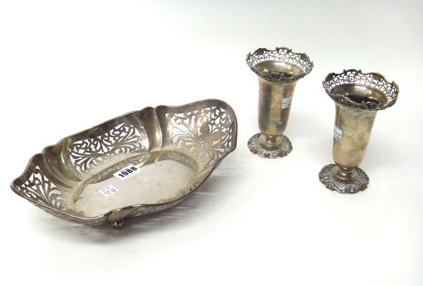 Silver, comprising; a bread or fruit basket of shaped oval form, having scroll pierced decoration, raised on four spherical feet, Birmingham 1928, len