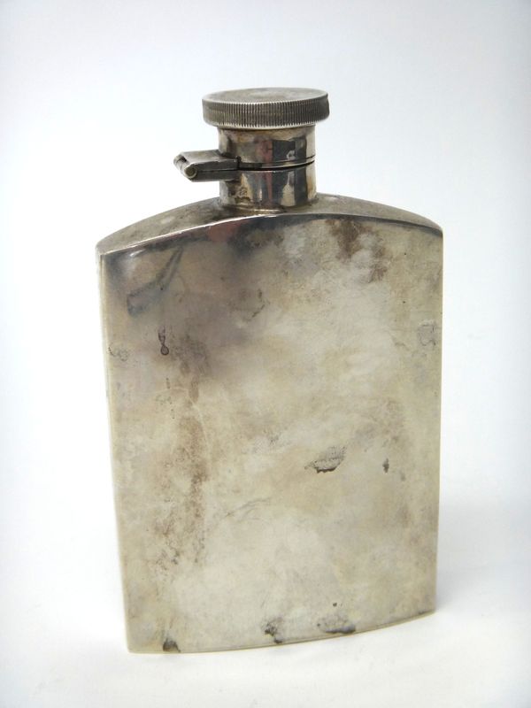 A silver spirit flask of curved rectangular plain form, with a milled edged circular top, Birmingham 1937, height 13.5cm, gross weight 180 gms.