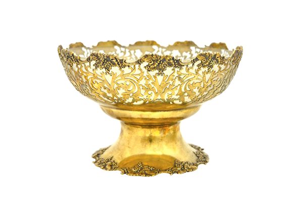 A silver gilt fruit basket, with pierced foliate and scrolling decoration, within a shaped rim cast with fruiting vine and on a similarly decorated sh