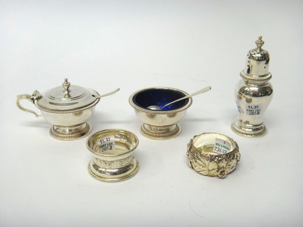 Silver, comprising; a circular salt, London 1978, a pepperette, London 1973 and a mustard pot, London 1978, by Mappin & Webb, with two blue glass line