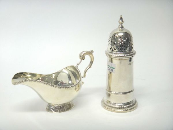 A silver sugar caster, of tapered cylindrical stylized lighthouse form, Sheffield 1979, by Mappin & Webb and a silver sauceboat, with a scrolling hand