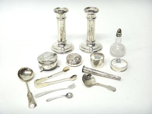Silver and silver mounted wares, comprising; a pair of candlesticks, each on a circular base, loaded, Birmingham 1912, height 12.5cm, two napkin rings