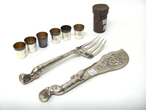 A pair of Danish fish servers, with pierced and engraved decoration, detailed Clement and a set of six French spirit tots, monogram engraved with a le