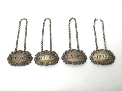 Four similar decanter labels, each of shaped oval form, with a cartouche shaped border, comprising; Madeira, probably London 1810, Port and Claret, pr