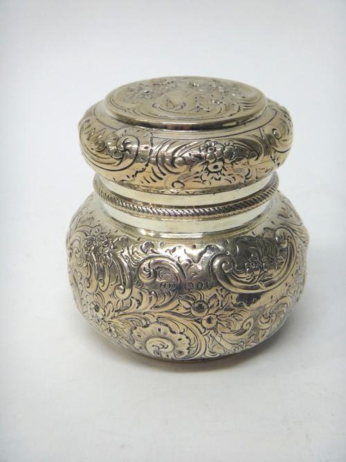 A Victorian silver tea caddy, of bun form, embossed with birds, floral and foliate scrolls, the pull-off lid with a China man motif, London 1890, weig