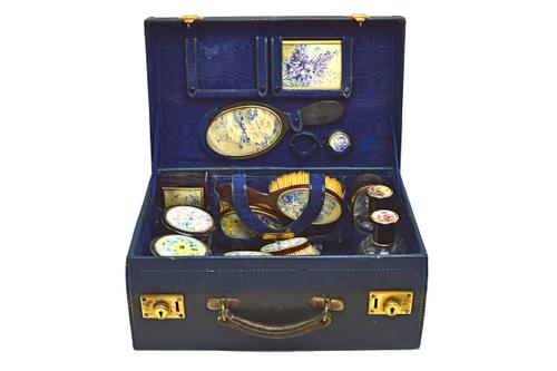 A French tortoiseshell travelling part toilet set, with a blue leather case, comprising; fifteen pieces to include a pair of silver gilt mounted large