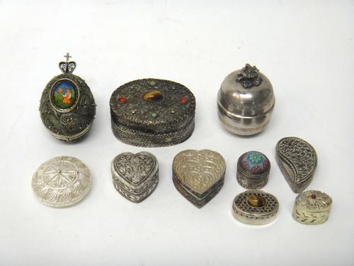 A filigree egg shaped folding case, opening to reveal a Russian lacquered panel depicting the seated figure of a lady of nobility, two heart shaped bo