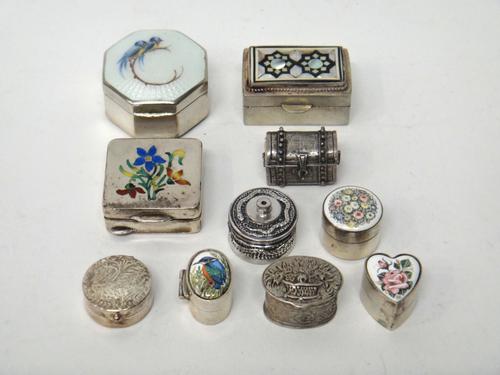 A Sterling silver and enamelled octagonal hinge lidded box, decorated with two birds and a spray, detailed 'Sterling', an enamelled square hinge lidde