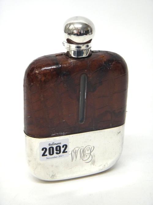 A silver mounted glass and partly leather covered glass rectangular spirit flask, the bottom with a pull-off silver beaker base, the silver top (detac