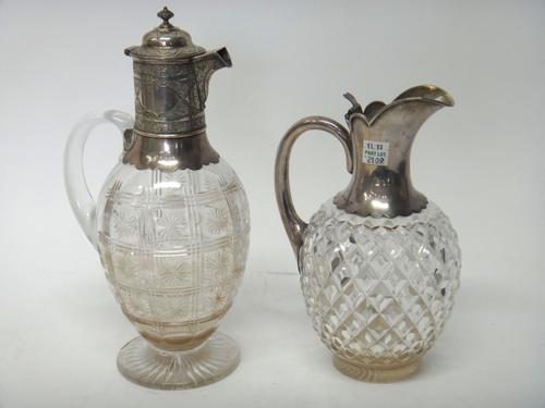 A Victorian silver mounted faceted glass claret jug, of ovoid form, the mount with scrolled decoration, London 1879 and another Victorian silver mount