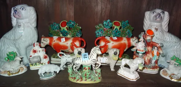 Staffordshire ceramics, including; a zebra, sheep dogs and two reproduction cow vases. (qty) Rost