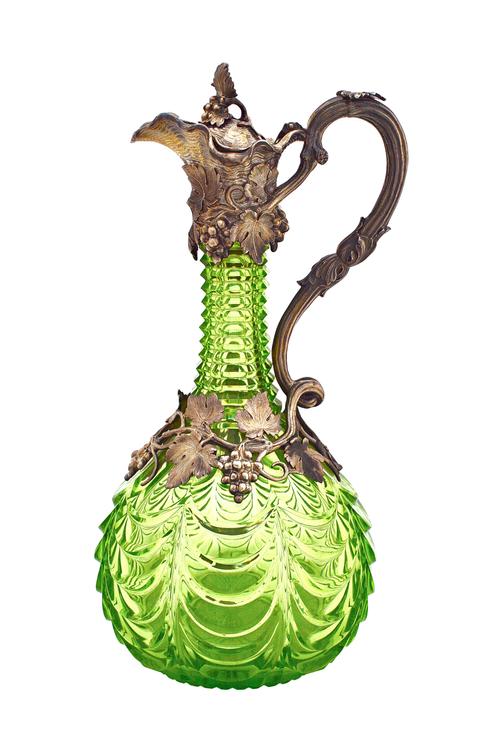 A Victorian silver mounted faceted green glass claret jug, the mount, the handle and the hinged lid with fruiting vine motifs, in the naturalistic tas