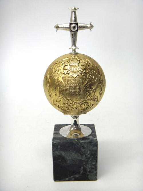 A silver and silver gilt limited edition ornamental model of spherical form, decorated with The Royal Coat of Arms, opening to reveal The Prince of Wa