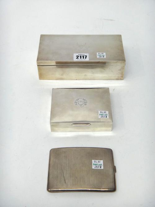 An Indian rectangular hinge lidded cigarette box, crest and motto engraved, detailed Madras Silver, a rectangular table cigarette box, crest and motto