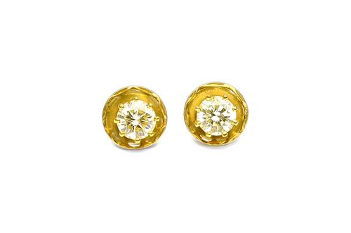 A pair of gold and diamond set single stone ear studs, each claw set with a circular cut diamond, the diamonds weight approximately 1.05cts each, in a
